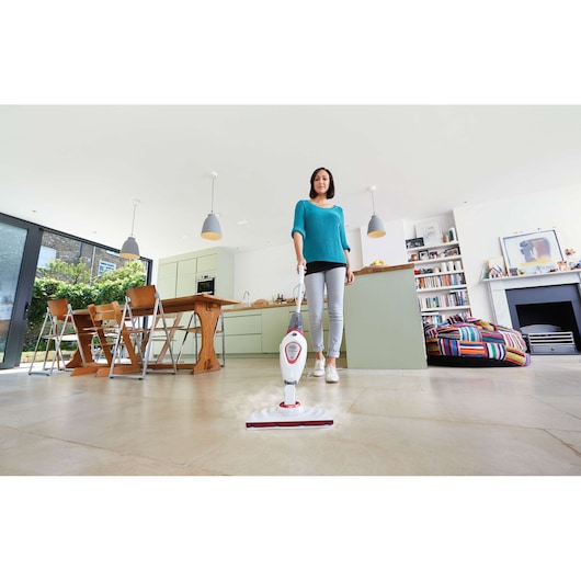 BLACKDECKER BDS1616R steam mop in use on tile floor in modern kitchen-living area, product photography