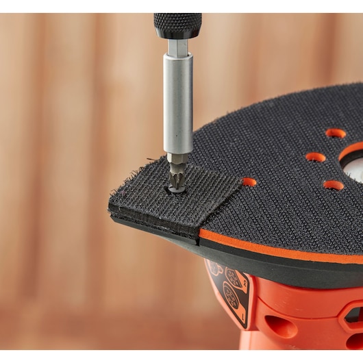 BLACKDECKER BEW200 detail sander with screw bit attaching Velcro pad, close-up angle.