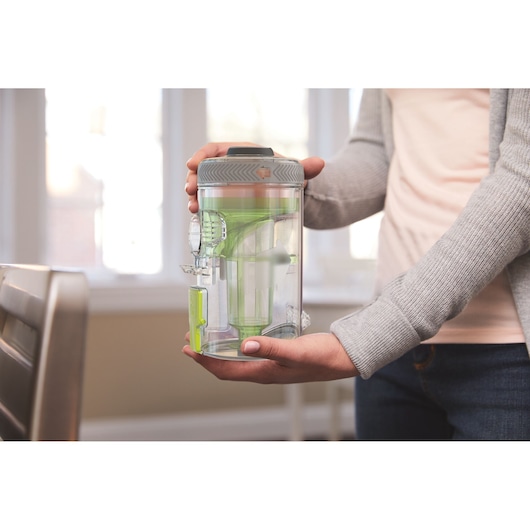 BLACKDECKER BHFEV362DA vacuum dust container held by person indoors.