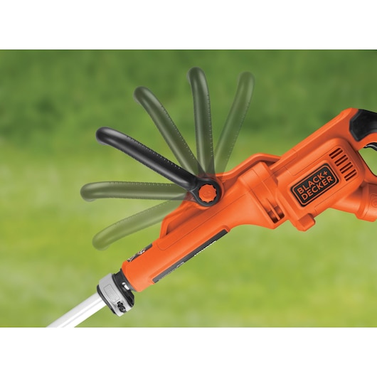 BLACK+DECKER GL933 grass trimmer side view highlighting adjustable black handle and orange body on blurred green background.