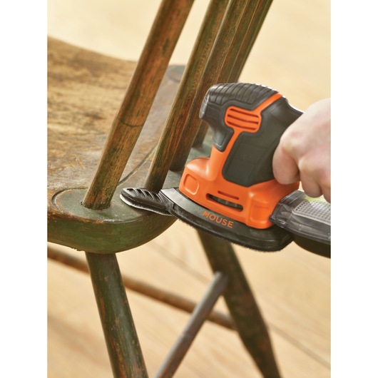 BLACKDECKER KA2000KA10 detail sander sanding an old green wooden chair close-up.