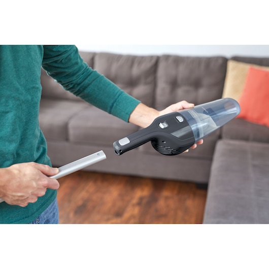 BLACKDECKER NSVA315J handheld vacuum cleaner being assembled in living room.