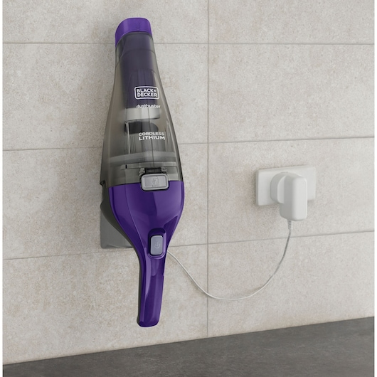 BLACKDECKER NVC215WP cordless handheld vacuum in purple mounted on a wall charger, front angle.
