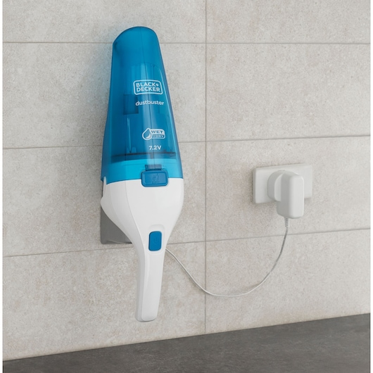 Photo of BLACK+DECKER WDC115WA handheld vacuum with blue and white body, wall-mounted and charging.