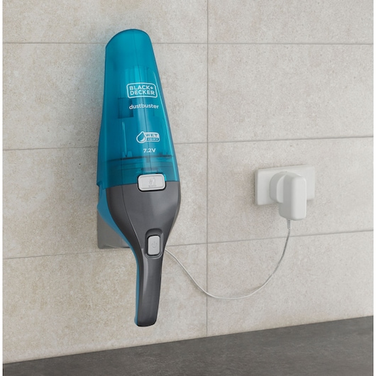 BLACKDECKER WDC215WA handheld vacuum mounted on wall, blue and gray, charging via power outlet.