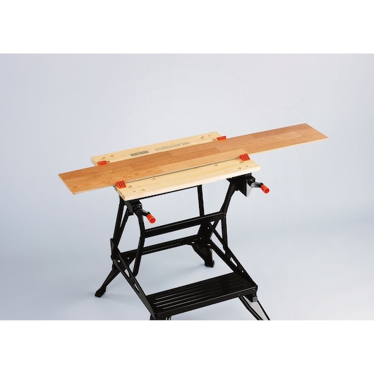 BLACKDECKER WM536 foldable workbench with wooden top on white background, photography from high angle.